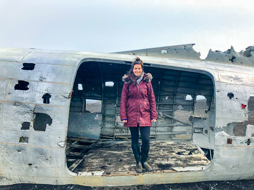 Standing in the crashed US navy plane in Sólheimasandur's in Iceland